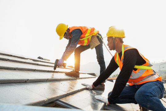 roof extension roof installation engineer roof-construction workers stand on tiled roof