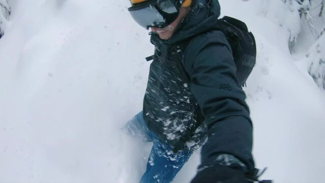 Snowboarder Carving Powder Between Trees Holding Action Camera Pole