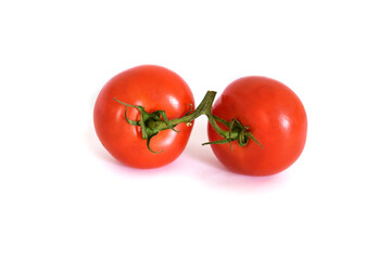 Two fresh red tomatoes isolated on a white background