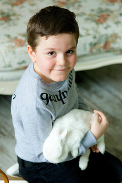 A handsome boy with a live Easter Bunny. The inscriptions on the T-shirts in Armenian are Gratitude and love.