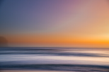 Fototapeta na wymiar Orange glow panning sunrise seascape