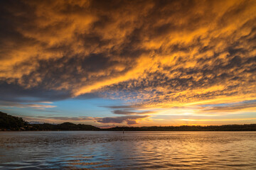 Sunrise by the bay with cumulonimbus clouds