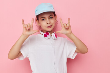 Portrait of happy smiling child girl wearing headphones posing emotions isolated background
