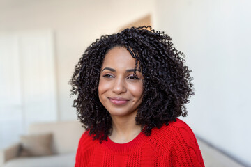 Portrait of a beautiful woman smiling at home. African woman in casual looking at camera with copy...