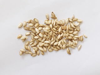 Heap of pumpkin seeds isolated on white background