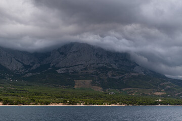 Mountain Biokovo disappears in dark clouds on the Croatian coast