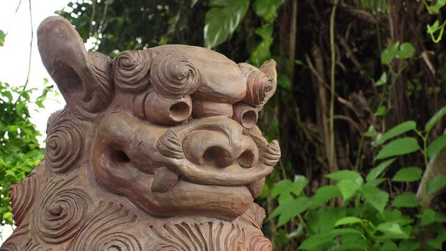 NAHA, OKINAWA, JAPAN - AUG 2021 : View of Lion Dog statue (Shisa) at the street. It is a traditional Ryukyu cultural artifact and decoration, a cross between a lion and a dog, from Okinawa mythology.