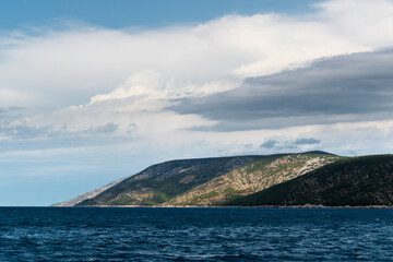 Fototapeta na wymiar Sunspots on the island of Brac in Croatia from the Adriatic Sea during a cloudy day