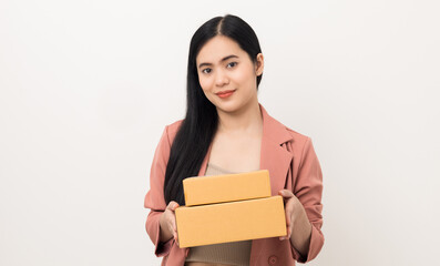 Young beautiful asian woman with many parcel cardboard standing on isolated white background. Delivery woman holding lot of parcel box sending to messenger.