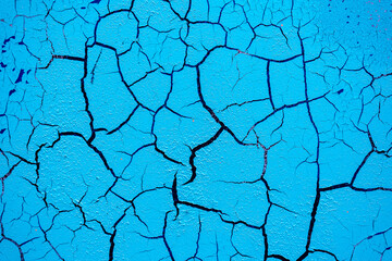 Cracked and damaged painted surface of a building or wall. Texture, aged paint background