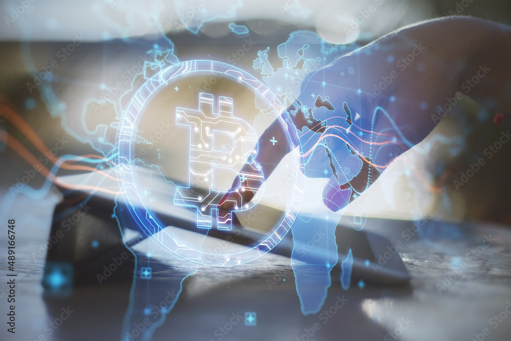 Poster Close up of hand at desktop using tablet with creative glowing global bitcoin hologram on blurry outdoor background. Blockchain and crypto concept. Double exposure.