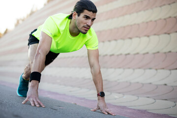 Young sexy man training outside. Fit handsome man doing exercise