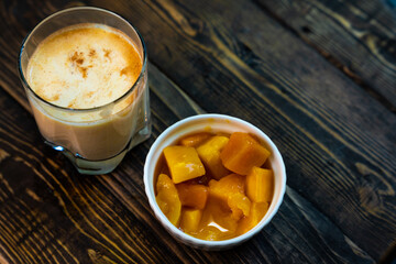 Yellow Indian mango yoghurt drink Mango Lassi or smoothie with turmeric and saffron.