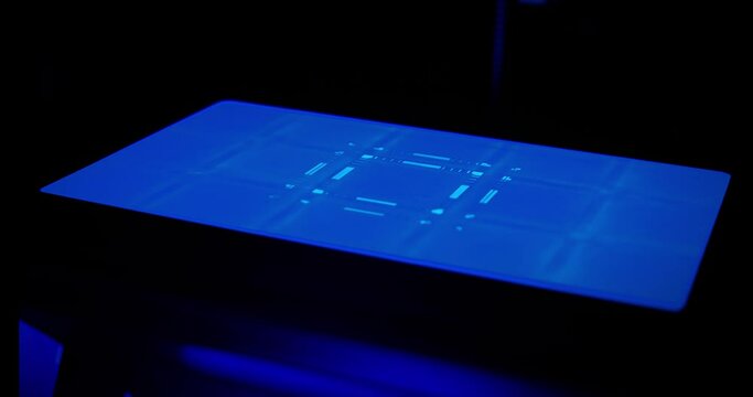 MSLA 3D Printer screen. A screen of MSLA 3D printer running, msaking UV light in geometric shapes to create a 3D printed piece.