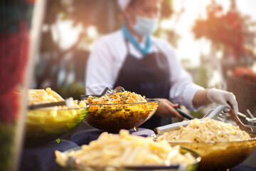 Chef Cater makes main dish or appetizer for serving in wedding ceremony party or outdoor hotel yard garden events. Catering with Buffet or fine dining event. Food delicious cooking catering concept