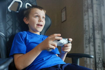child playing computer games. Positive emotions. Facial expression. Childhood 
