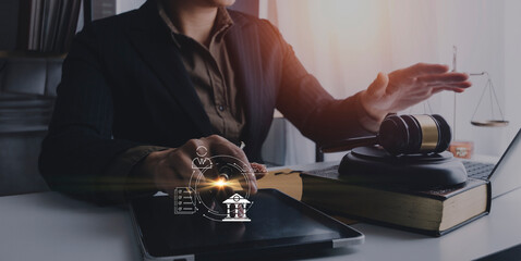 Justice and law concept.Male judge in a courtroom with the gavel, working with, computer and docking keyboard, eyeglasses, on table in morning light