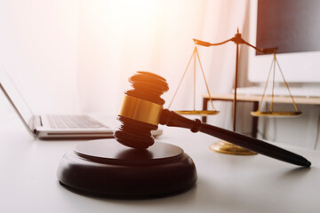 Justice and law concept.Male judge in a courtroom with the gavel, working with, computer and...