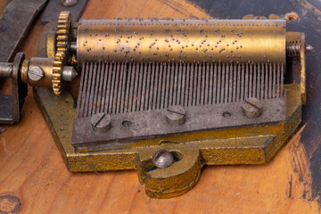 Closeup of an antique roller mechanism with two Christmas carols from 1902 inside of a rotating...