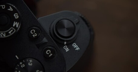 Finger pressing shutter release button on camera taking picture, close up