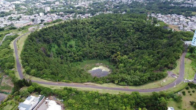 An extinct ancient volcano called Trou-aux-Cerfs surrounded by jungle forest, video from a drone of a volcano in Mauritius