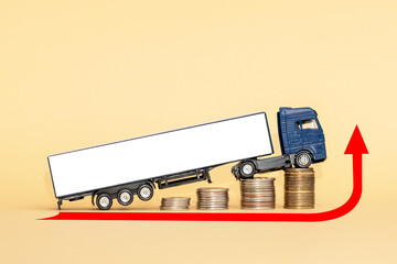 A model of a truck with a trailer and coins are located on a yellow background. Increasing the cost of fuel. Increase in freight rates.