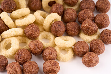 Variety of cold cereals, quick breakfast for kids overhead shot. Quick breakfast. Chocolate balls isolated on a white background. Rings isolated on a white background. 