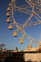 Yellow ferris wheel against blue sky in Manila Bay, Manila, Philippines