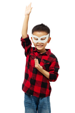 Happy kid playing superhero wearing red shirt and eye mask