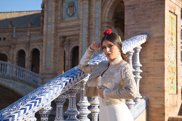 Portrait of young flamenco woman, Hispanic and brunette, with typical flamenco dance suit, with...