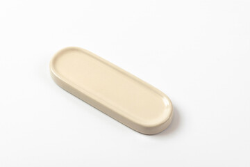 Porcelain chopstick rest on a white background