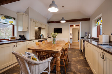 Traditional styled luxury kitchen with prominent wood table