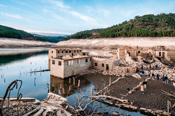 Low water level due to extreme drought at the Lindoso dam. Old village became visible again. Portugal, Spain, Aceredo, Galicia. - obrazy, fototapety, plakaty