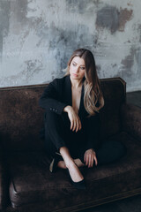 Obraz premium Beautiful girl, blonde, in a black suit, office style, work clothes, no war, Ukraine