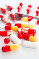Colorful and white pills on a white background