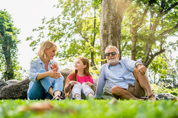Fototapeta premium Happy family parent and child relax in weekend holiday lifestyle park outdoor nature background.