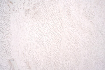 Background of natural white wall Pamukkale calcium travertine in Turkey, asymmetric pattern close-up. Pamukkale.