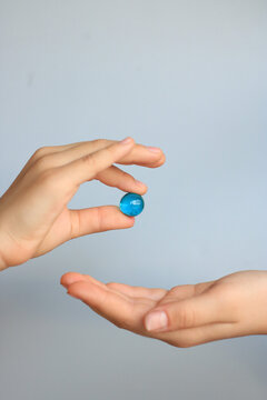 A child shares a precious pearl with a friend. Conceptual photo of reconciliation and friendship