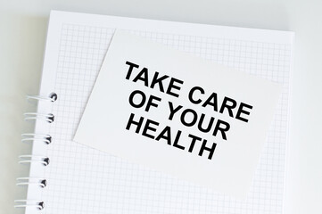 medical concept. Take care of your health inscription on a white card on a notepad