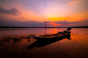 Native fisherman boat at The Lake on Sunset.Sunset over Lake , Sisaket province, Thailand,ASIA.