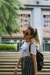 tourist walking down stairs in the streets of singapore