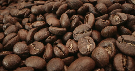 Macro shot roasting coffee beans, filmed in a dark key the smoke emanating from the roasting of coffee beans. Fragrant coffee beans are roasted smoke comes from coffee beans.