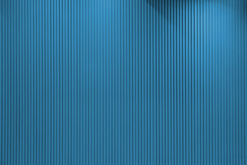 Vertical line textured blue wall with lights hitting it from different angles
