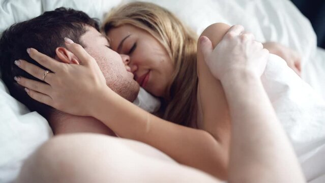 sensual couple embracing in bed. Passionate man and woman enjoying sensual foreplay. Sexy lovers kissing in bedroom in underwear. Relationship and intimate of romantic lovers, sexual activity in happy