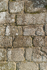 Texture of a stone wall. Old castle stone wall texture background. Stone wall as a background or texture. Marble texture decorative brick, wall tiles made of natural stone. Granite. Building materials