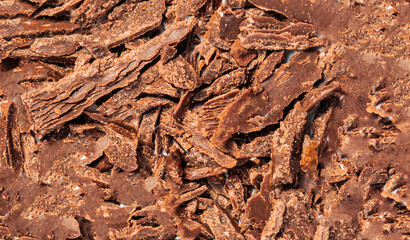Grated Chocolate as a textured background. Crushed dark chocolate Pattern. Wallpaper. Top view.