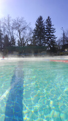 Outdoor public swimming pool in sunny day.