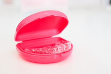 Clear aligners to straighten teeth for adults and teenagers with pink case