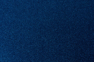 Dark blue, shiny and glittering surface. Abstract background. Events, celebrations. Trendy backdrop for your design. Texture with glitter.