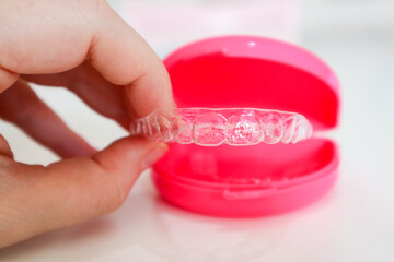 Clear aligners to straighten teeth for adults and teenagers with pink case